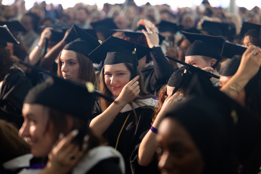 Students move their tassels to the side.