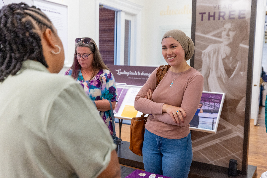 Students talk to staff members at an orientation event