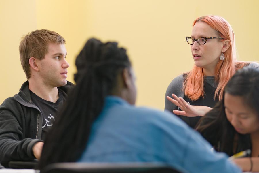 Post-baccalaureate program director instructing male and female students in class.