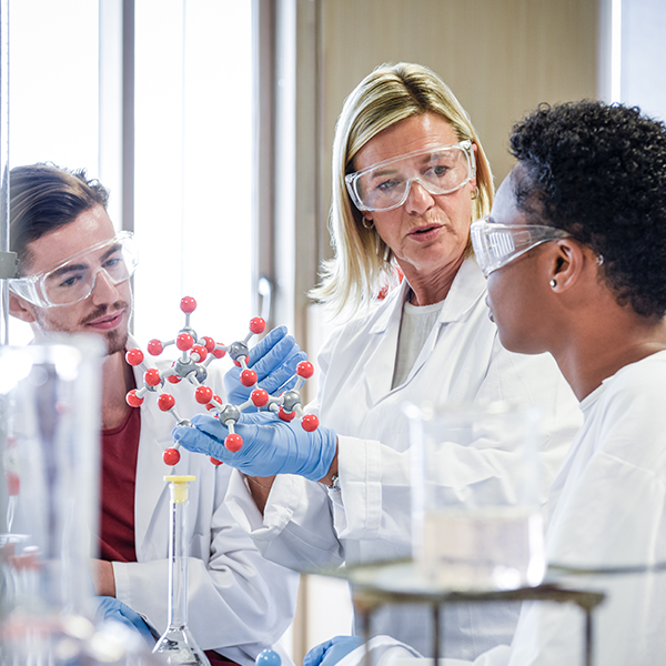 A medical sciences graduate program students talks with her professor in a stairwell.