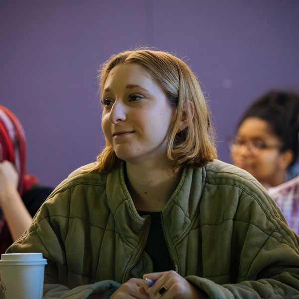 An Agnes Scott theatre student listens in class.