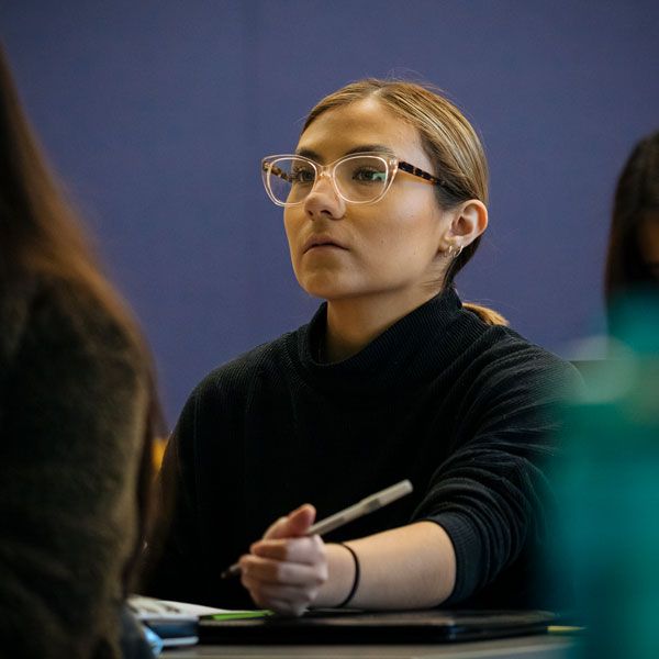 An Agnes Scott public health major student takes notes during a lecture.