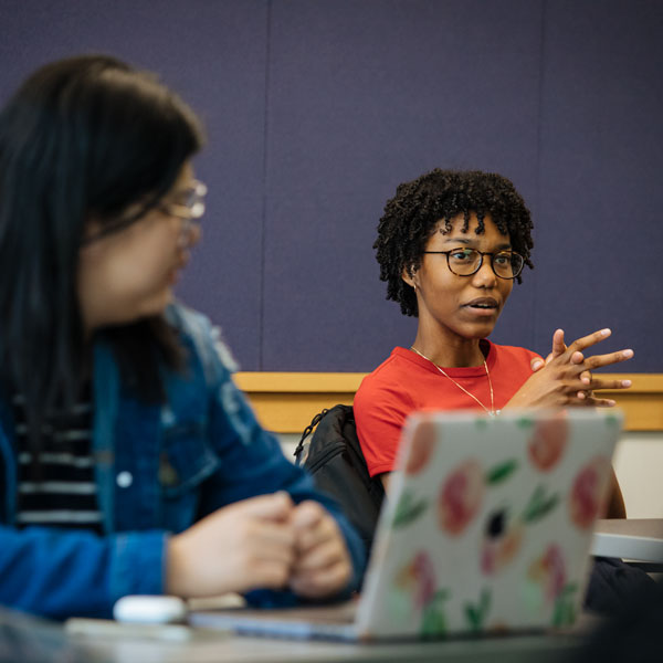 An Agnes Scott nursing major student folds her hands while talking in class.