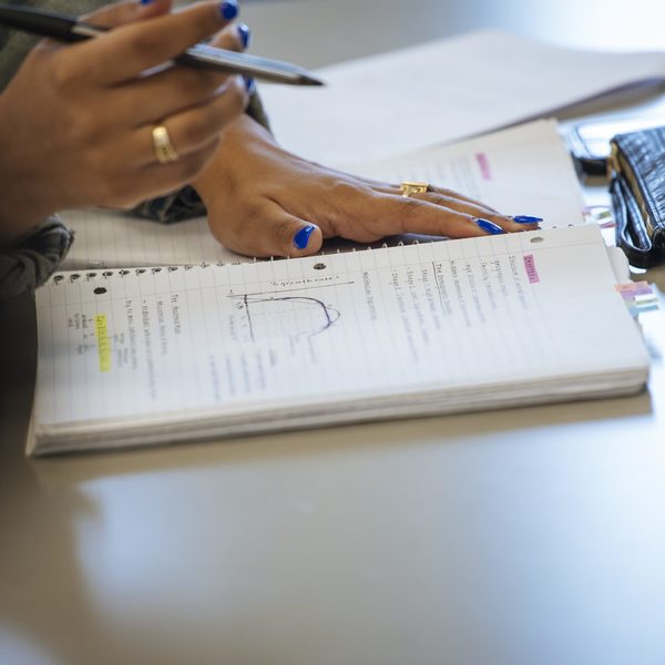 Handwritten notes and graphs in a biology major student's notebook.