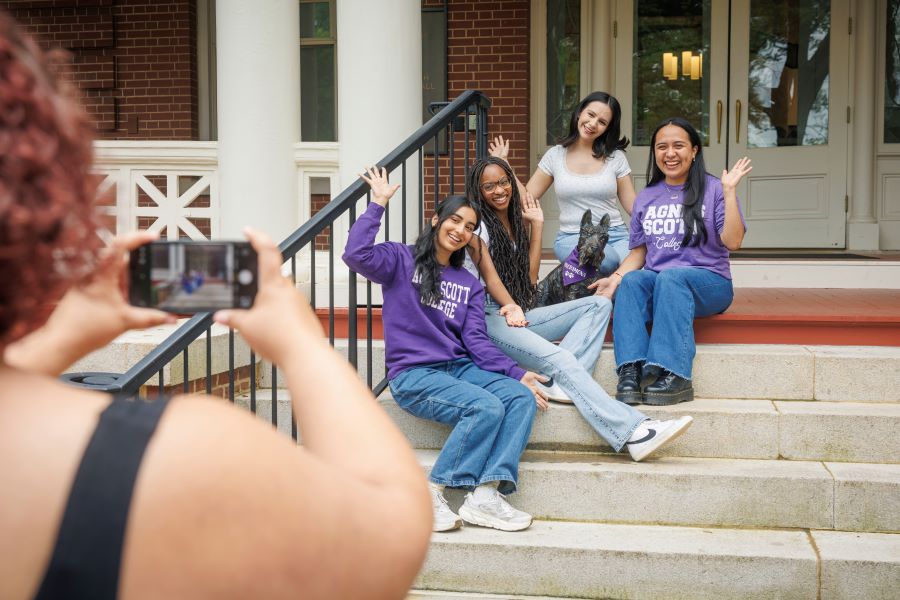 Students sitting on steps taking a picture