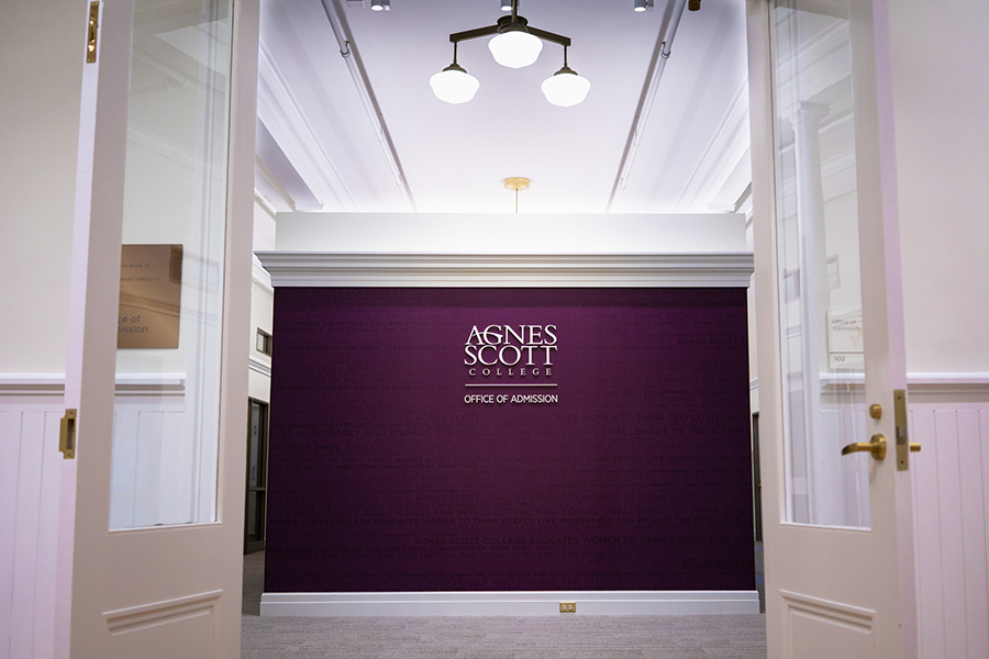 Entrance to the admission office- a purple wall reads "Agnes Scott College"