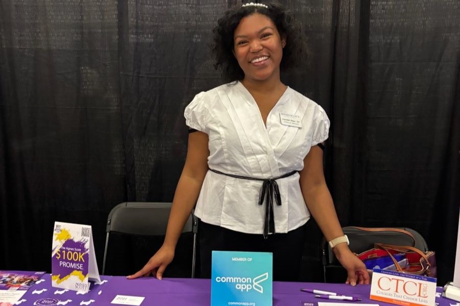 Staff member standing behind a table