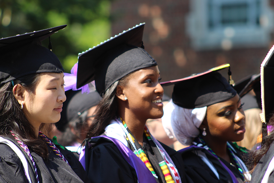 Several students wearing commencement caps and gowns.