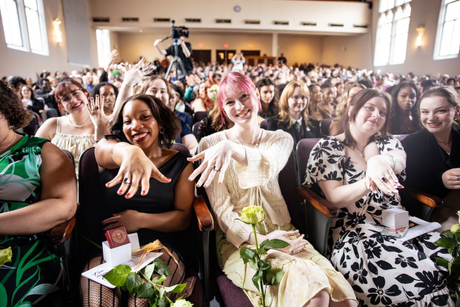 Students holding up black ring