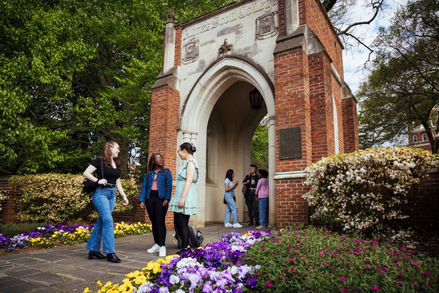 Flowers on campus beside Agnes Scott sign