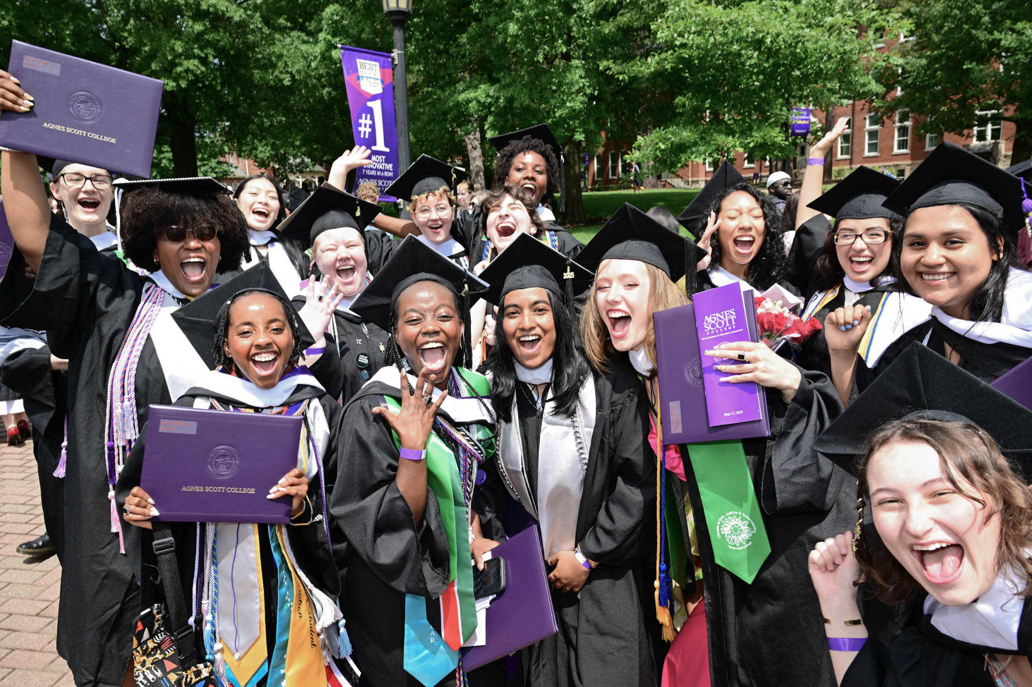 Agnes scott graduates in their caps and gowns, celebrating their big day