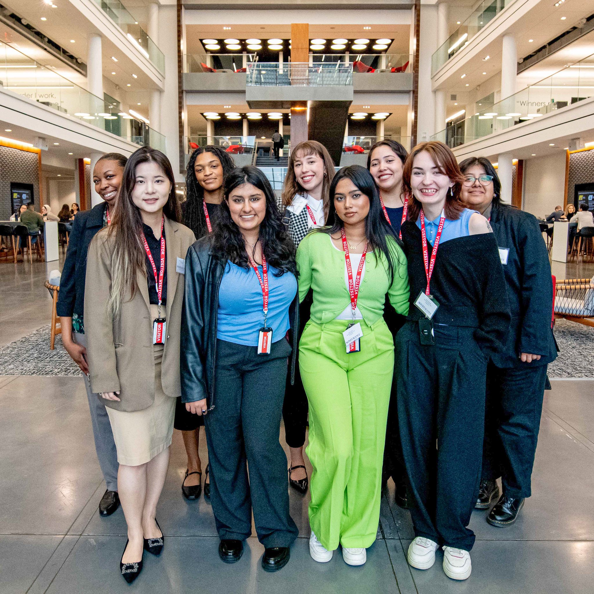 eight Agnes Scott students standing tall together and smiling directly at the camera