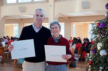Two staff members posing for a photo in Evans Dining Hall at a Holiday Gathering
