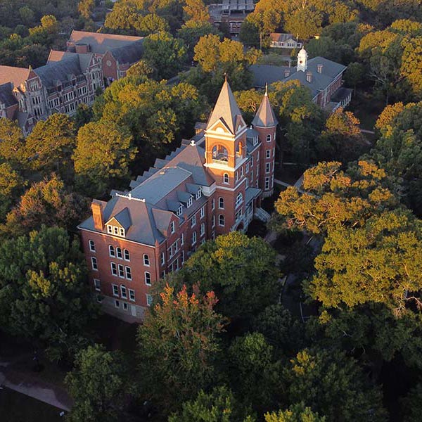 Aerial view of Main Hall and surrounding tree canopy - fall colors in the morning light