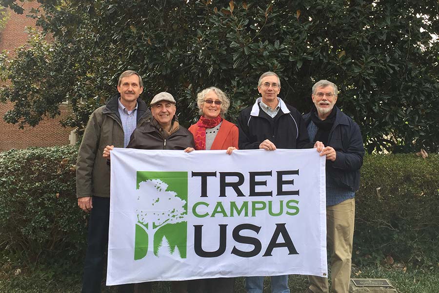 Honor tree recipients holding a Tree Campus USA banner