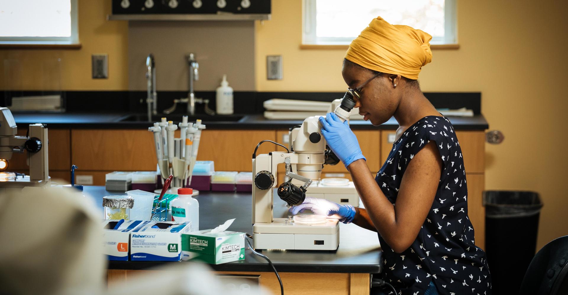 woman using a microscope