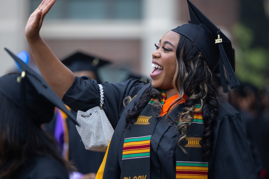 A student waves to a family member off camera