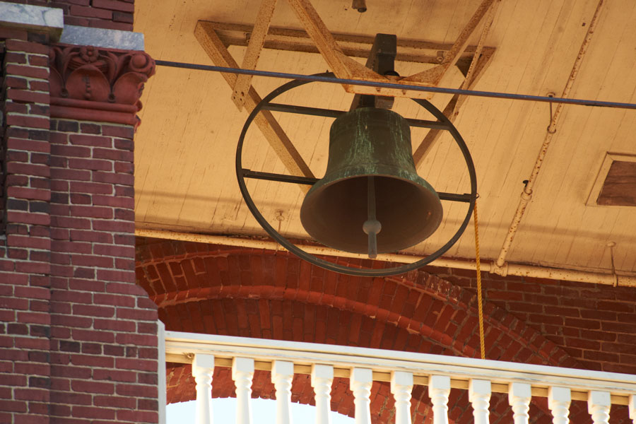 A close up of the bell ringing in the belltower.