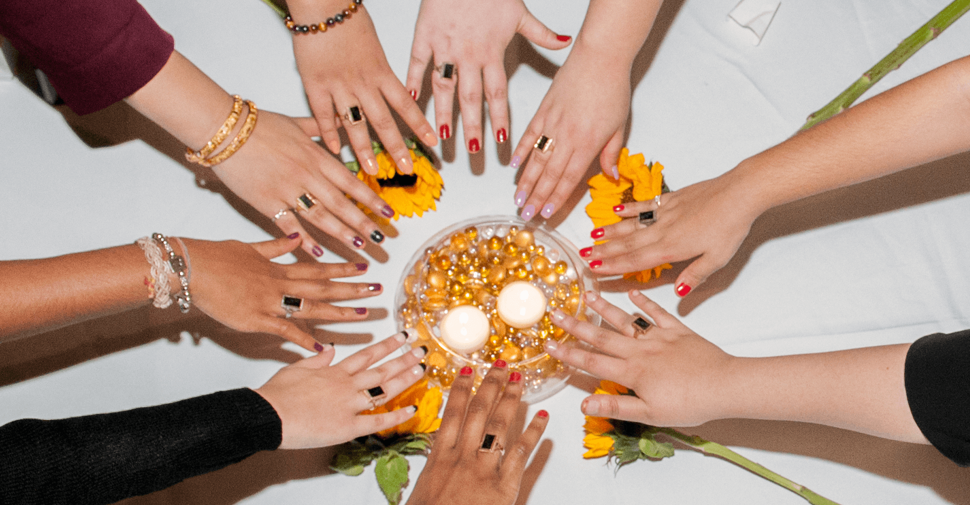 a circle of hands with rings on them