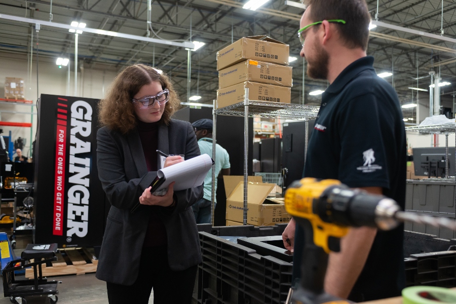 A professional woman and man in a Grainger facility