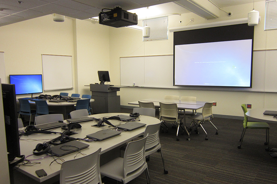 View of Campbell G27 showing desks with laptops and projection screen