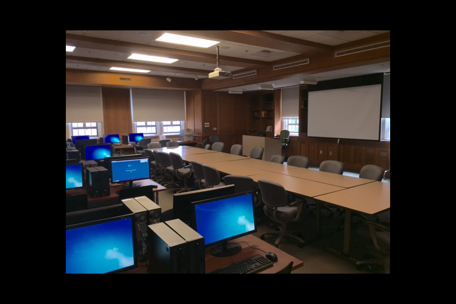 View of McCain 211 with computers, desks, and project screen