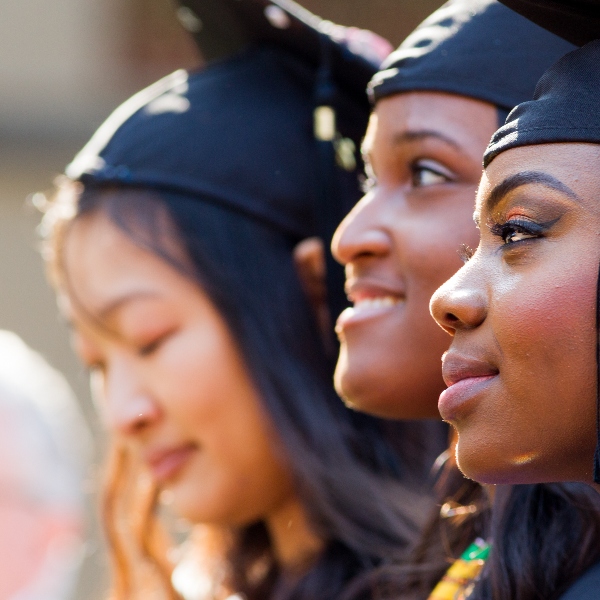 Three graduates in caps and gowns