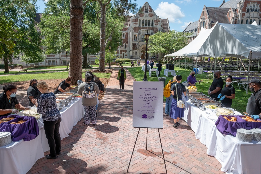attendees of new student orientation wait for food to be served in the tent on the Main quad
