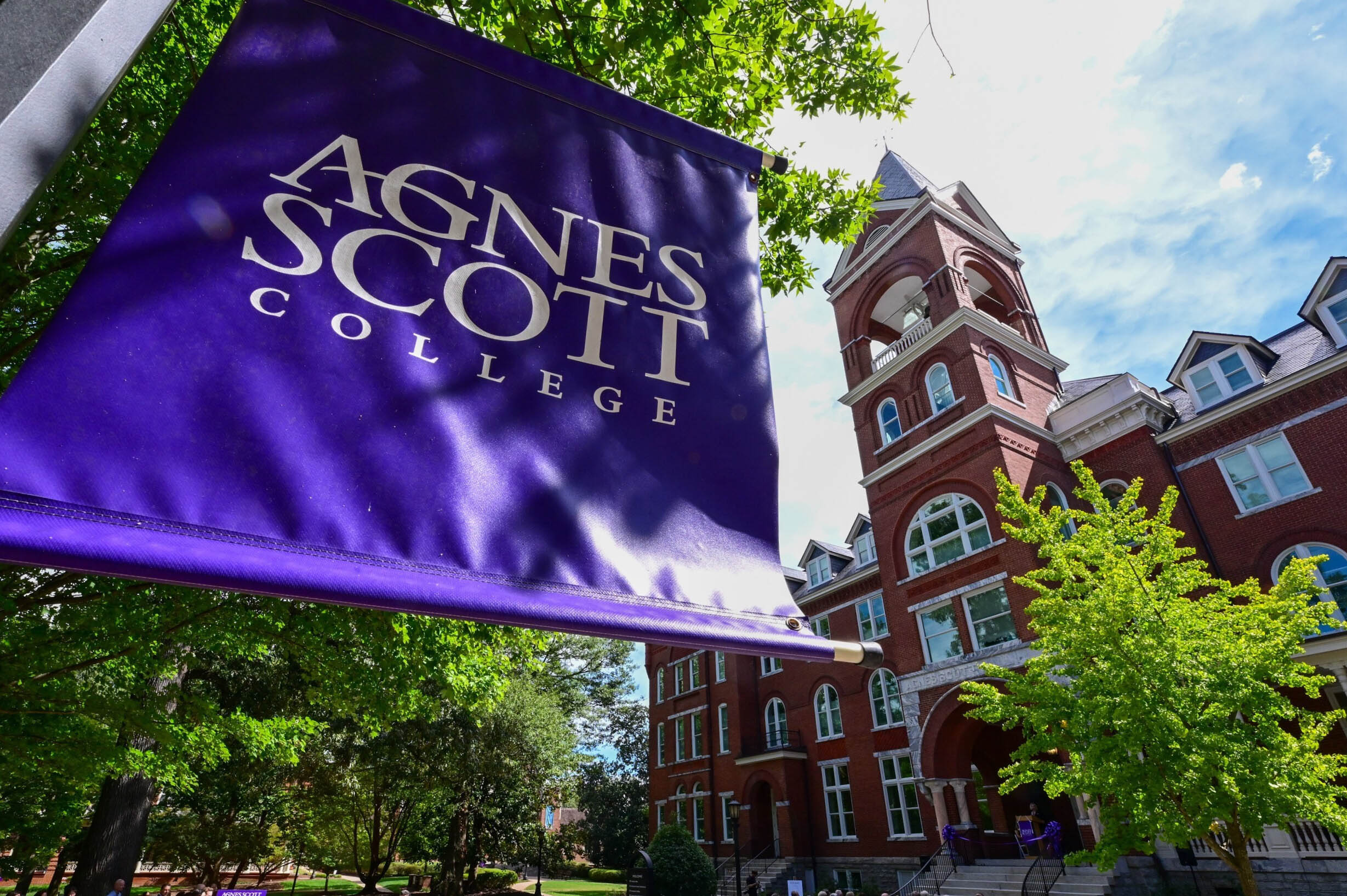 ASC purple banner in the foreground with Main Hall in the background