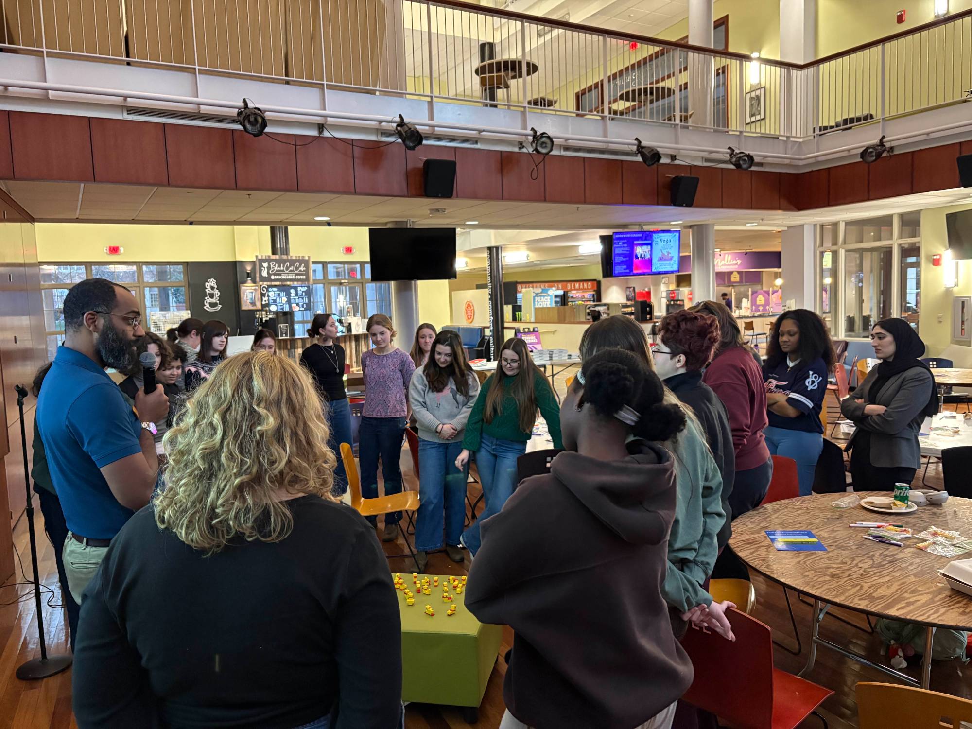 students engaging in a workshop standing in a circle