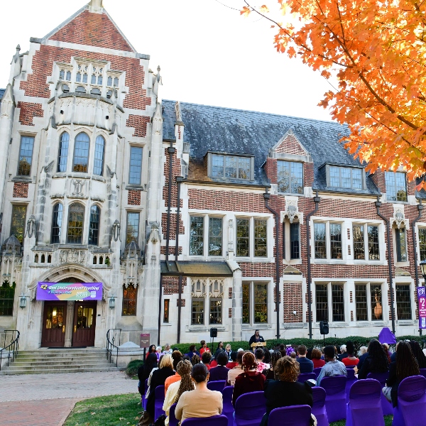 Buttrick Hall behind a ceremony. 