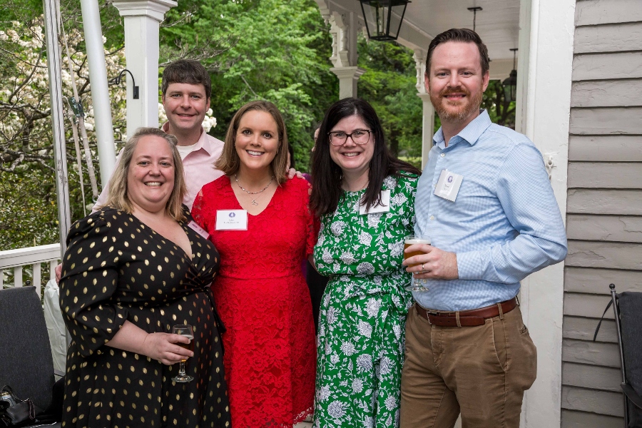 A group of people dressed up stand together for a photo. 