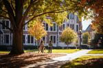 Move to four female students walking on campus slide