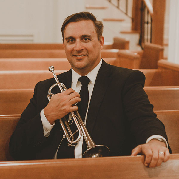 Wayne Bennet holding a trumpet