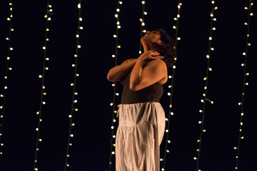 woman standing still against backdrop of lights