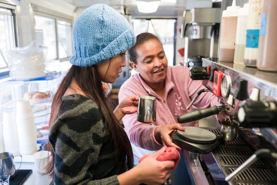 two women making coffee