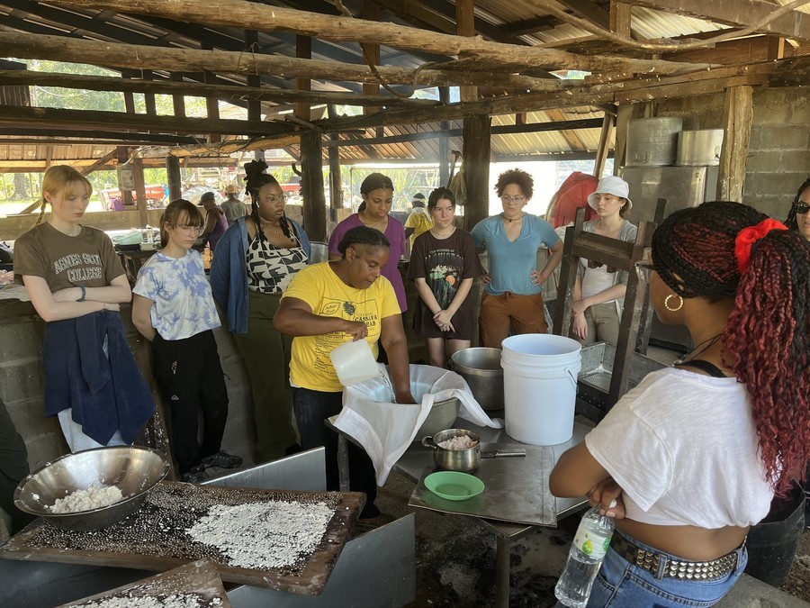 Students learning to make cassava bread in Belize.