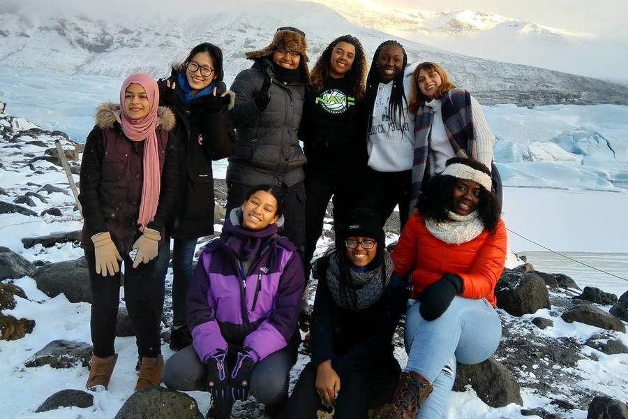 Students pose for group photo in a snowy landscape in Iceland.