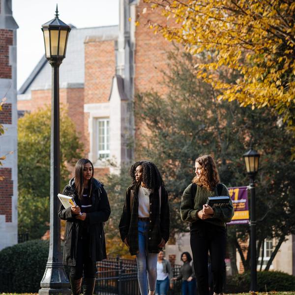 three female students walking on campus