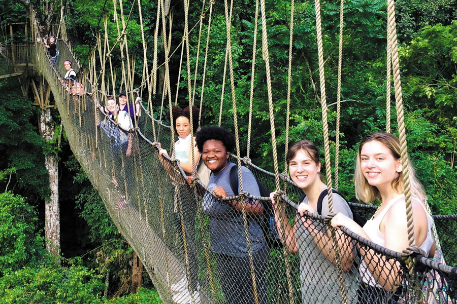 Students in Ghana on a rope bridge