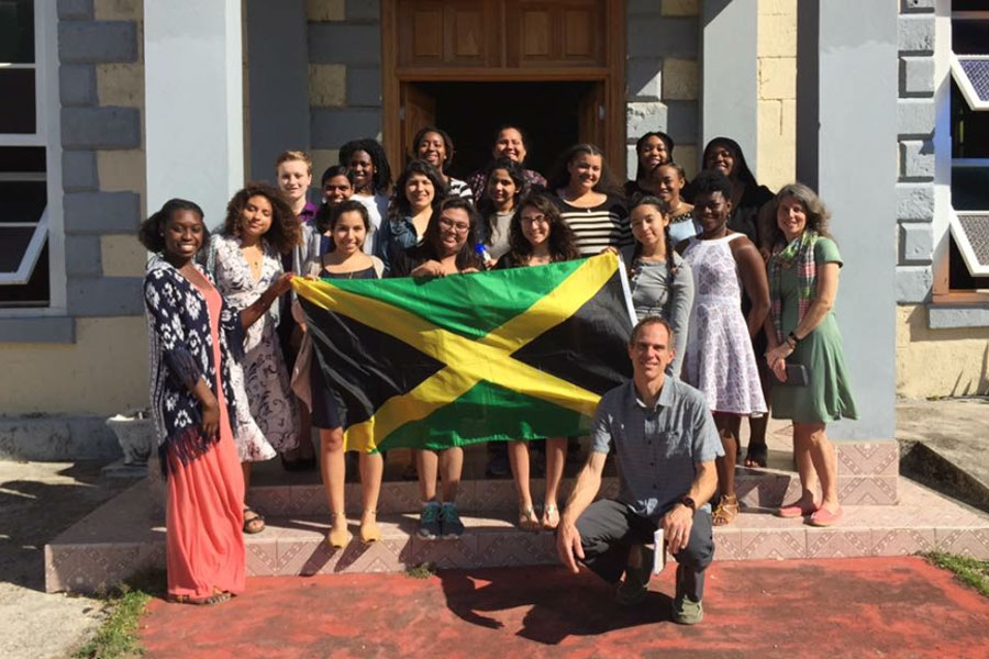 A group of students pose with the Jamaican flag.