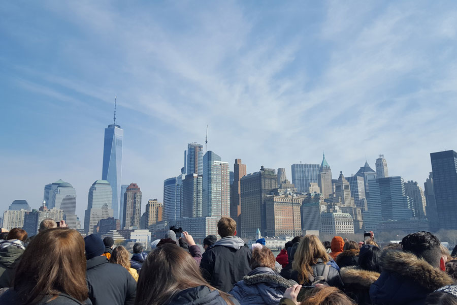 A group of people look at the New York City skyline.